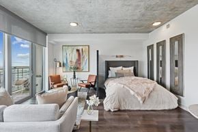 Frisco apartment for rent - A bedroom with a large bed and a painting on the wall.