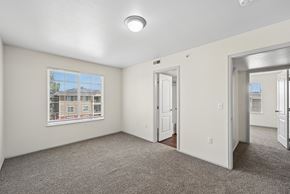 Lafayette apartment for rent - A room with a carpeted floor and a window showing a building outside.