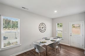 Morrisville townhouse for rent - Furnished dining room with ample natural lighting inside a townhome at Porchlight Brier Creek