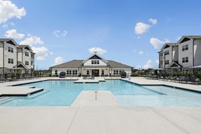 Jackson apartment for rent - A large swimming pool in front of a building with a white roof.