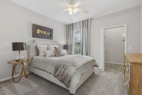 Tampa apartment for rent - A bedroom with a large bed and a ceiling fan.