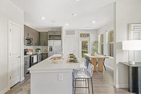 San Antonio apartment for rent - a white kitchen with a large island and a dining table