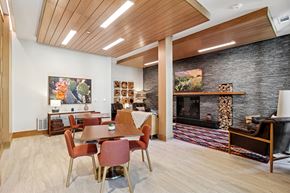 Carrollton apartment for rent - A modern dining room with a wooden table and chairs.