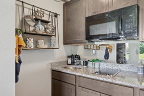 San Marcos apartment for rent - A kitchen with a microwave oven mounted above a countertop with a sink.