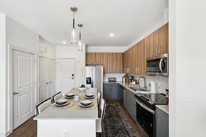 Huntsville apartment for rent - A modern kitchen with a dining table set for two.