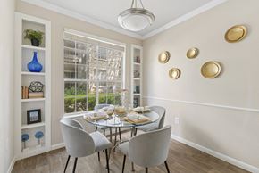 San Antonio apartment for rent - A dining room with a table set for two and a view of a tree outside the window.