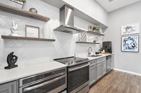 Chapel Hill apartment for rent - A modern kitchen with a black oven and wooden shelves.
