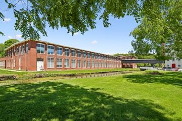 North Smithfield apartment for rent - A red brick building with a green lawn in front.