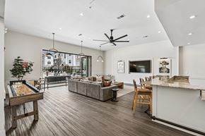 Nashville apartment for rent - A modern living room with a pool table and a view of the city.