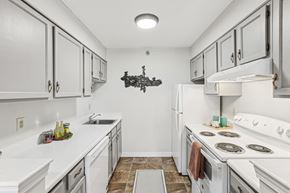 Madison apartment for rent - a white kitchen with white appliances and white cabinets