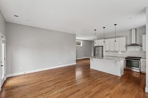 Nashville apartment for rent - A kitchen with a wooden floor and white cabinets.
