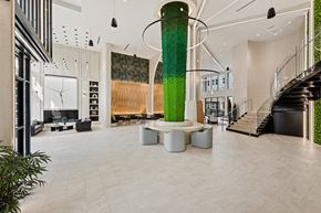 Huntsville apartment for rent - A large green pillar is the centerpiece of a spacious, modern interior.