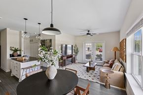 Jackson apartment for rent - A modern kitchen with a black table and a ceiling fan in the living room.