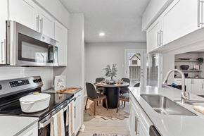 Arlington apartment for rent - A modern kitchen with a dining table set for two.