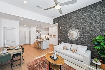 Carrollton apartment for rent - A living room with a grey couch and a wooden coffee table.