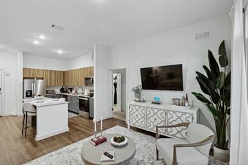 Huntsville apartment for rent - A modern living room with a white sofa and a coffee table.