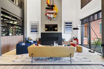 Huntsville apartment for rent - A living room with a yellow sofa and a fireplace.