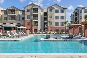 Bryan apartment for rent - A large swimming pool in front of apartment buildings.