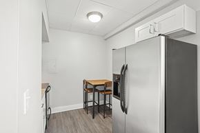 Nashville apartment for rent - A kitchen area with a refrigerator, a table and chairs.