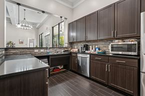 Concord apartment for rent - A kitchen with dark wood cabinets and a black counter top.