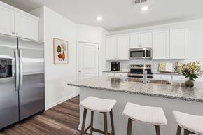 Dacula apartment for rent - A kitchen with white cabinets and a granite countertop.