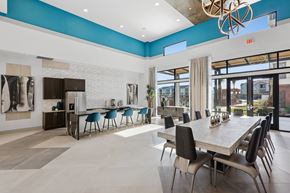 Bryan apartment for rent - A modern dining room with a long table and chairs.