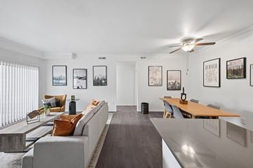 Littleton apartment for rent - A living room with a grey couch and a wooden table.