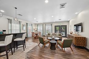 Lafayette apartment for rent - A well-lit, modern living room with a variety of seating options and a dining table.