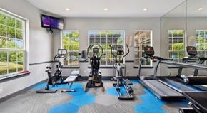 Grand Prairie apartment for rent - A gym with a variety of equipment including treadmills, stationary bikes, and weight machines.