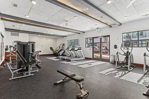 Atlanta apartment for rent - A spacious gym with a variety of equipment including treadmills, stationary bikes, and weight machines.