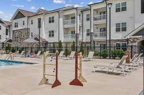 Nashville apartment for rent - A poolside with chairs and a climbing wall.