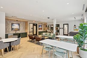 Austin apartment for rent - a communal area with tables and chairs and a living room