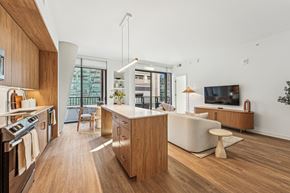 Bethesda apartment for rent - A modern kitchen with wooden cabinets and a white countertop.