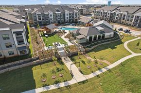 Fort Worth apartment for rent - A bird's eye view of a residential area with apartment buildings, a swimming pool, and a playground.