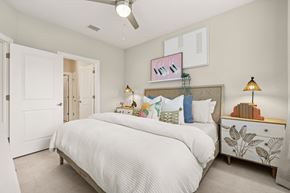 Palm Bay apartment for rent - A bedroom with a large bed and a ceiling fan.
