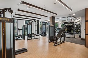 Dallas apartment for rent - A gym with a variety of equipment including TRX and a treadmill.