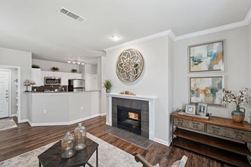 Dallas apartment for rent - A living room with a fireplace and a large painting on the wall.