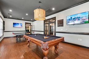 Grand Prairie apartment for rent - A room with a pool table and a television mounted on the wall.