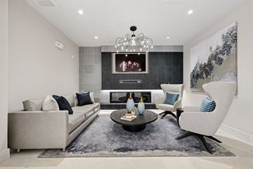 Huntsville apartment for rent - A modern living room with a grey sofa, a black coffee table, and a large painting on the wall.