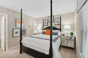 Winston Salem apartment for rent - A bedroom with a four poster bed and a white bedspread.