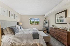 Eden Prairie apartment for rent - A bedroom with a large bed and a dresser.