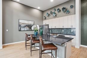 Sherman apartment for rent - A kitchen with a table and chairs and a painting on the wall.