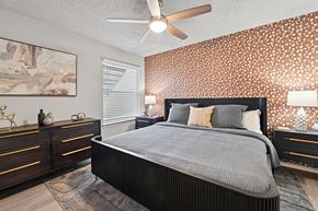 Arlington apartment for rent - A bedroom with a large bed, a ceiling fan, and a painting on the wall.