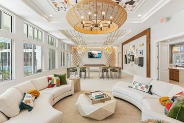 Palm Bay apartment for rent - A living room with a white couch and a wooden chandelier.