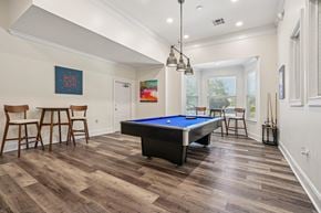 Concord apartment for rent - A pool table is in the middle of a room with wood flooring.