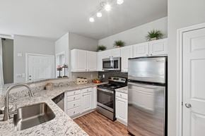 Dallas apartment for rent - A kitchen with white cabinets and stainless steel appliances.