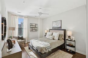 Huntsville apartment for rent - A bedroom with a large bed and a ceiling fan.