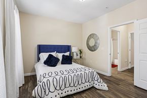 Atlanta apartment for rent - A bedroom with a bed and a mirror on the wall.