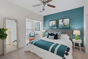 Durham apartment for rent - A bedroom with a large bed and a mirror on the wall.
