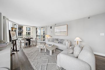 Chicago apartment for rent - A living room with a grey couch and a rug.